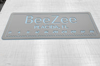 AquaGrip CT custom laser-engraved cooler pad BeeZee Placida FL — light gray over ice blue — 36 inch ruler flat lay shop photo