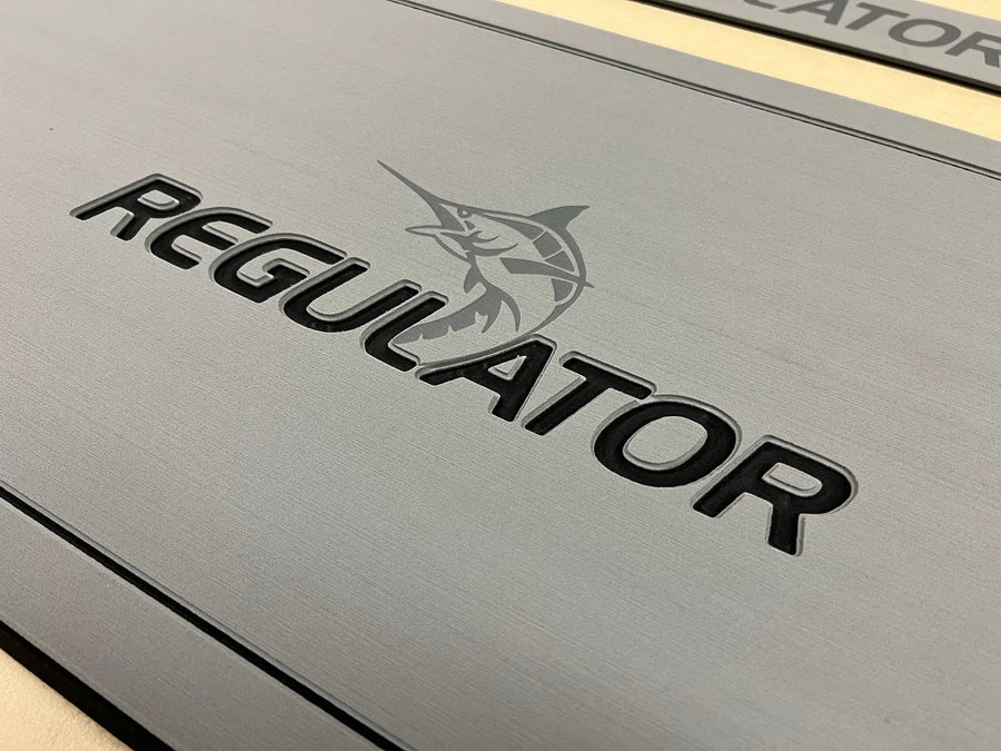 Custom AquaGrip helm pad engraved with the Regulator logo and marlin, gray PE/EVA foam with teak lines