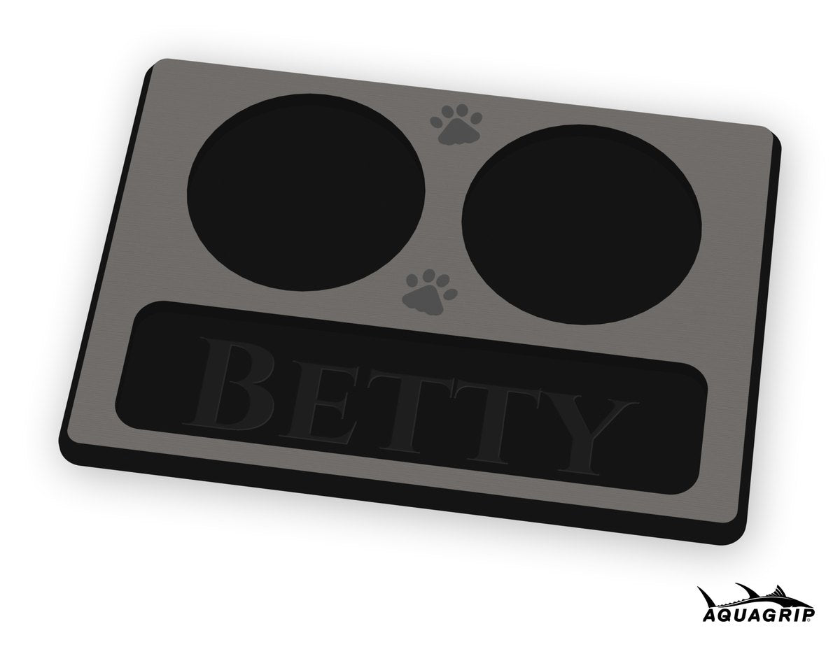 A custom dog bowl mat with two bowl pockets, a drip tray with the name Betty, and two paw prints